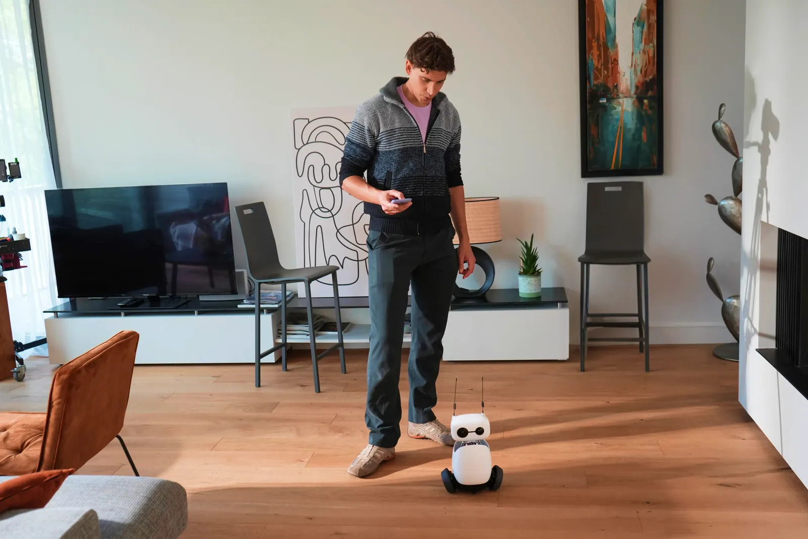 Reachy Mini on its hoverboard, driven from a phone across a living room