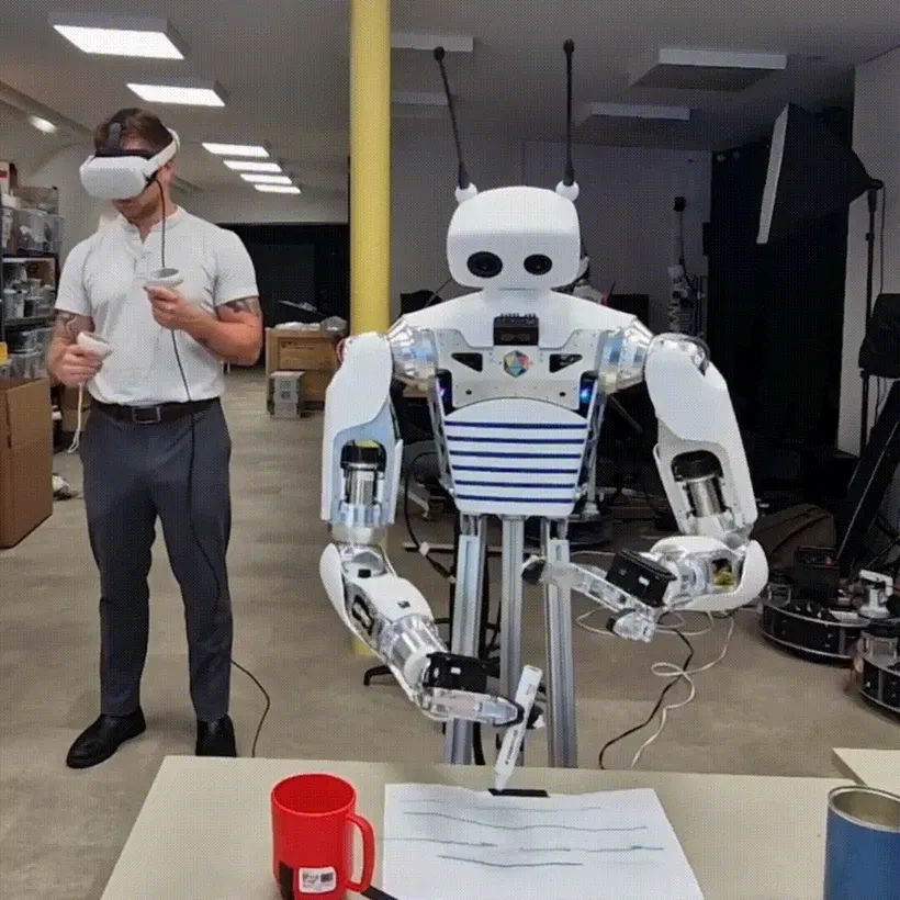 A person teleoperating Reachy 2 with a VR headset